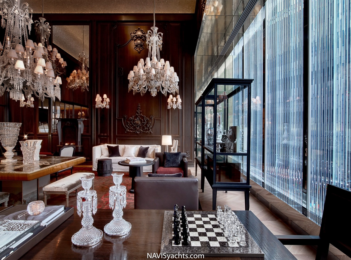 The Grand Salon with gilded ceiling and plush seating at Baccarat Hotel