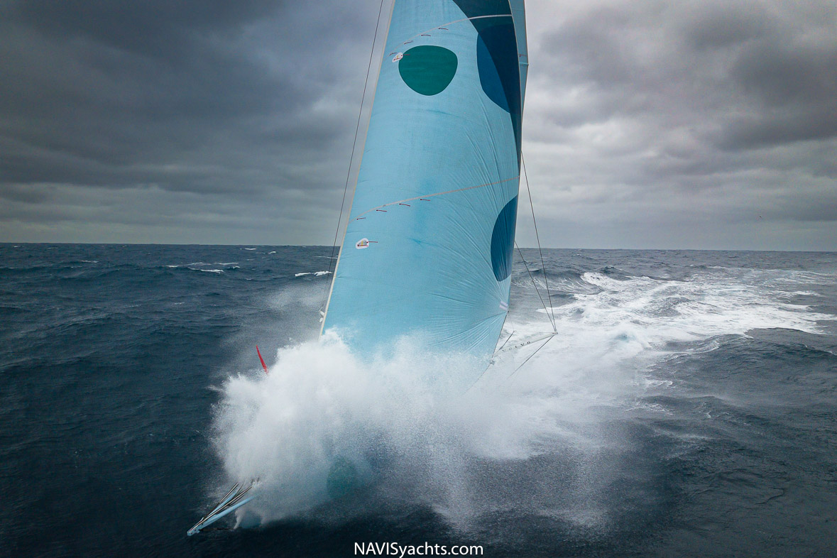 IMOCA yacht cutting through the waves during the Ocean Race