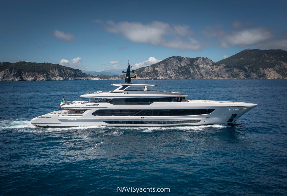 The luxurious Baglietto T52 hybrid yacht majestically docked in the picturesque bay of Portofino, symbolizing a new era in sustainable yachting.