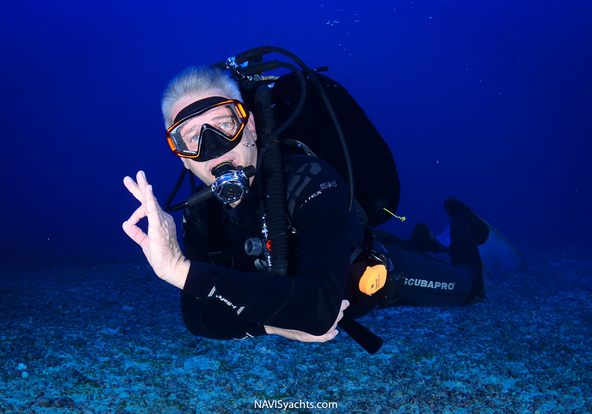 Scuba diver using a wrist-worn dive computer for safety