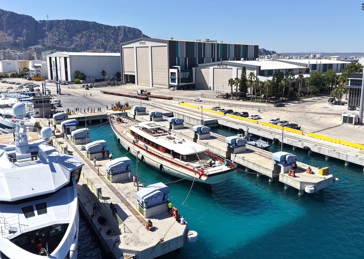 Detailed shot of the bow on the 62m ARES superyacht SIMENA, highlighting the fine varnished sipo mahogany joinery and classic trailboard design.