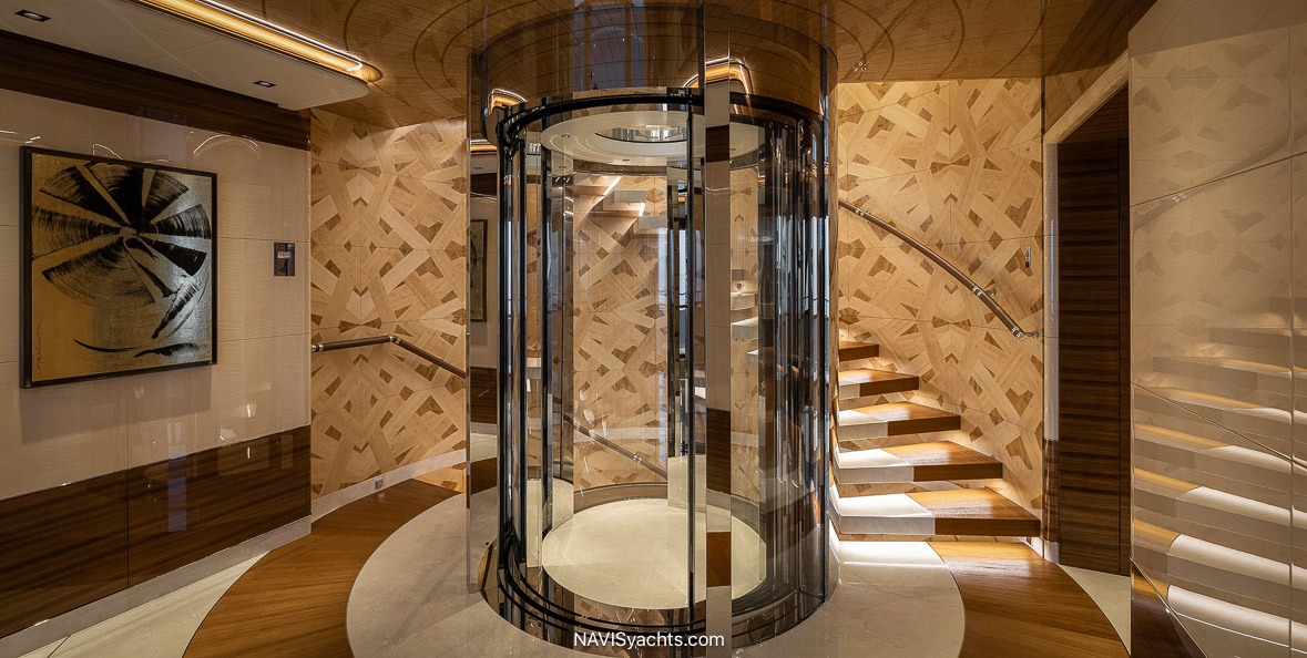 Amels Superyacht Energy. Exiting the glass lift in the guest lobby or taking the stairway to the main deck, guests move forward through the guest corridor to the owner’s office to starboard. 