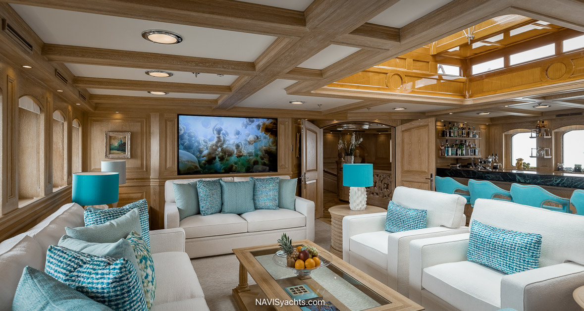 Nero yacht upper deck salon with marble bar, skylight, and light limed oak interiors