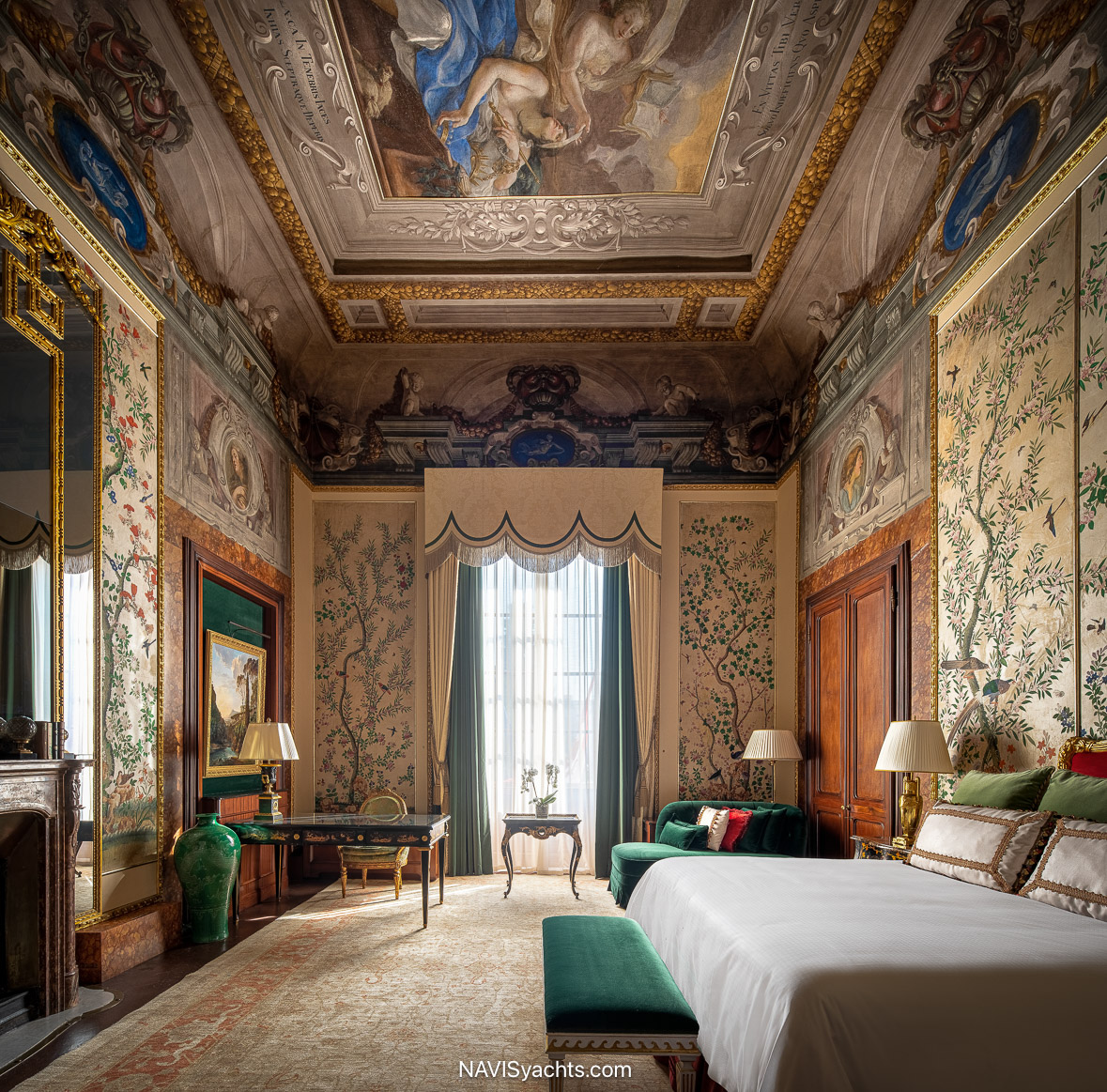 Luxury suite interior at Four Seasons Hotel Firenze with frescoed ceilings, elegant furnishings, and views over Florence