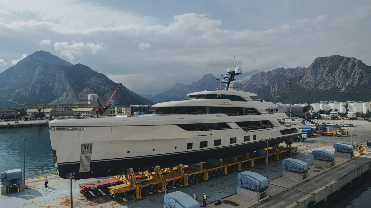 A sleek, modern superyacht cruising on open blue waters during a sunny day, showcasing modern marine architecture.