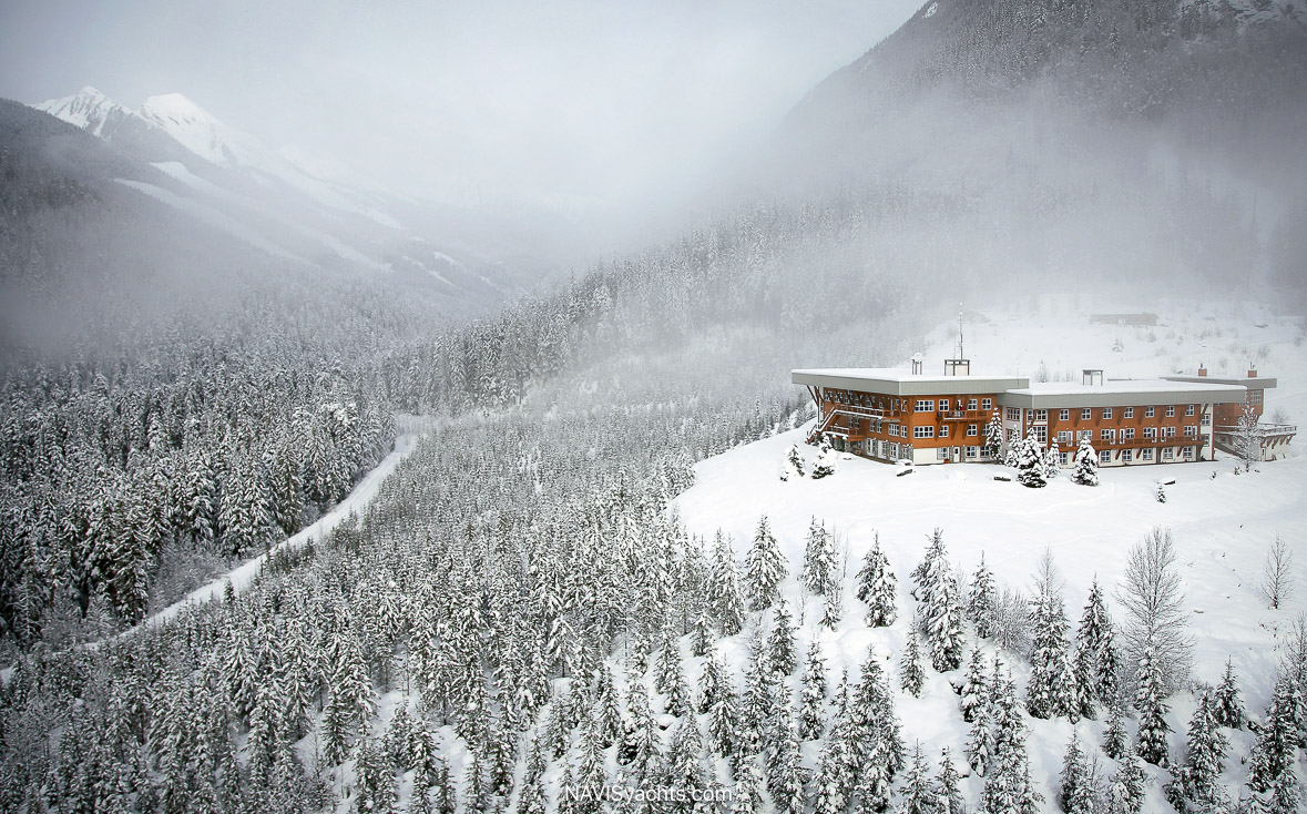     CMH heli-ski lodge surrounded by snow-covered mountains
