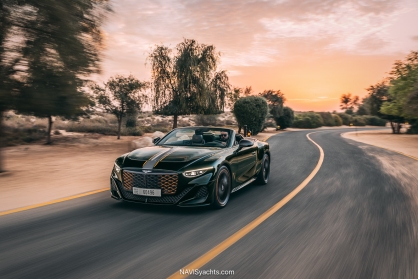 Front view of the Bentley Batur Convertible, focusing on the intricate grille that fades from a vibrant orange to black and the unique, sleek design of the headlamps.